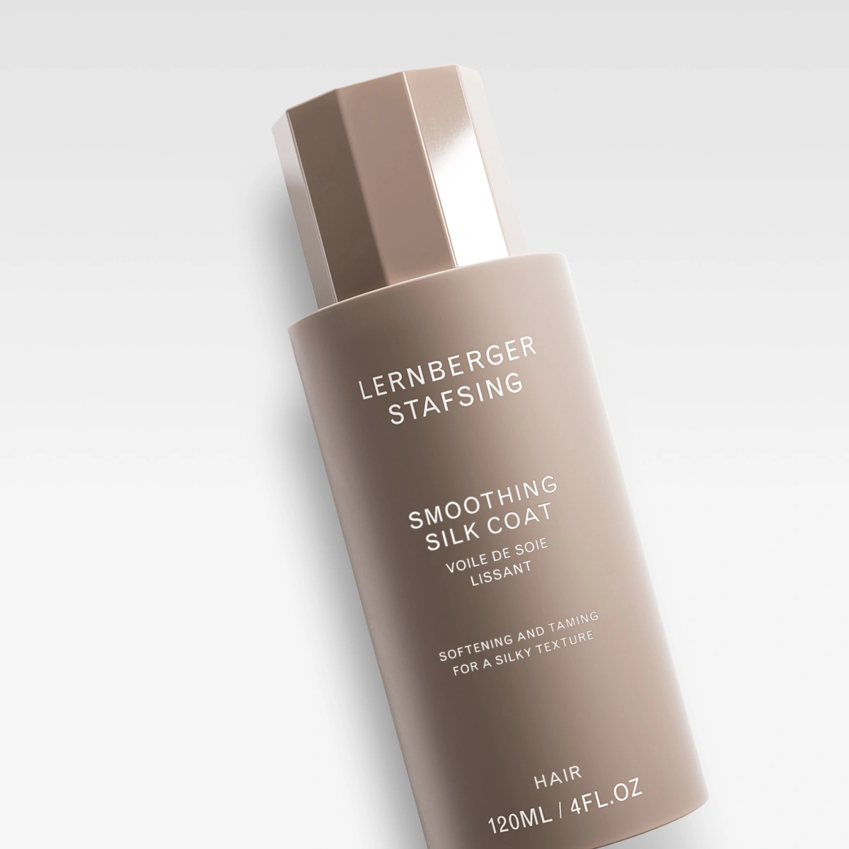 Lernberger Stafsing Smoothing Silk Coat hårpleieprodukt i beige flaske med tekst på etiketten.