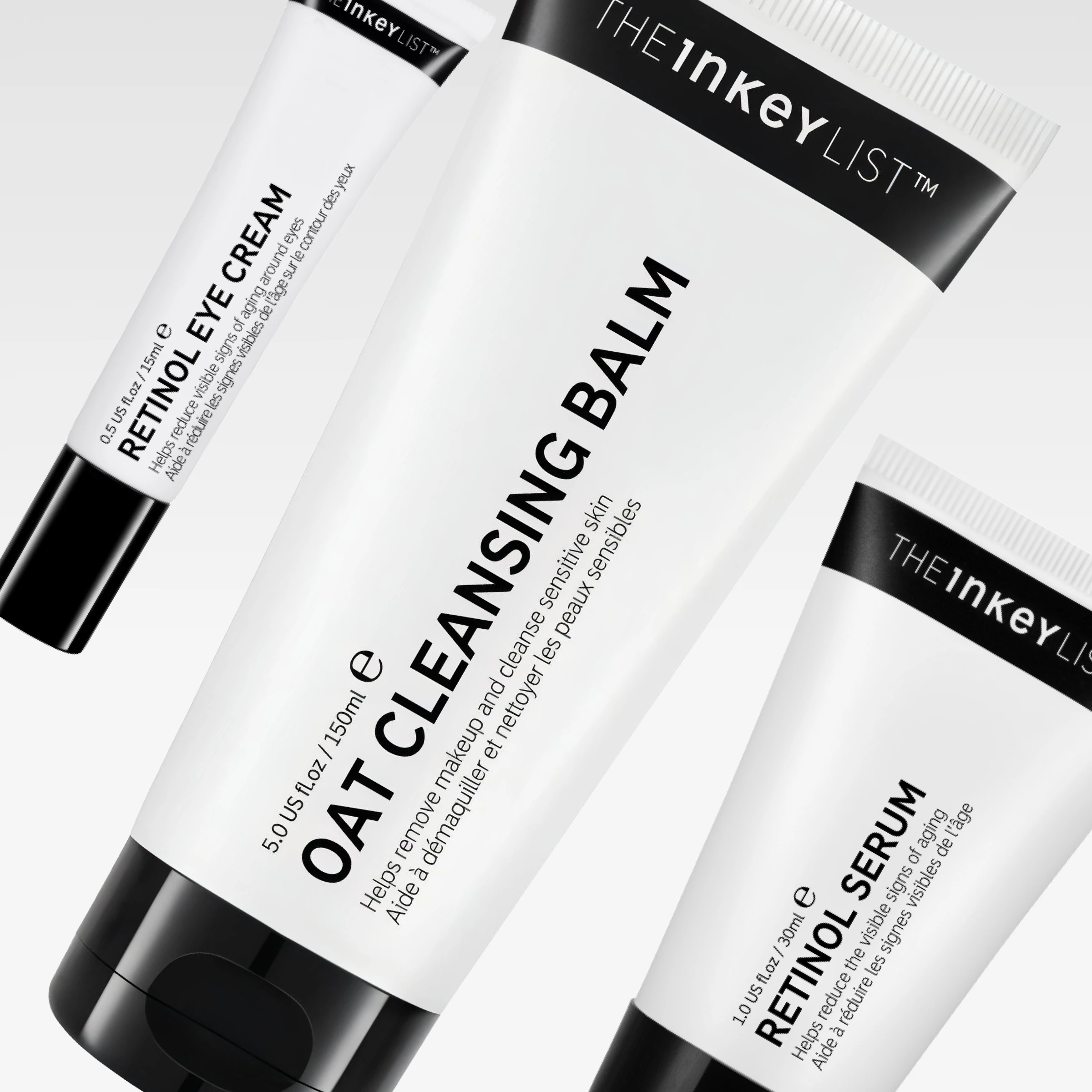 The INKEY List -ihonhoitotuotteet, mukana Oat Cleansing Balm, Retinol Eye Cream ja Retinol Serum valkoisissa tuubeissa mustalla tekstillä vaaleanharmaata taustaa vasten. Näkyvä teksti sisältää “helps remove makeup and cleanse sensitive skin” ja “helps reduce the visible signs of aging”.
