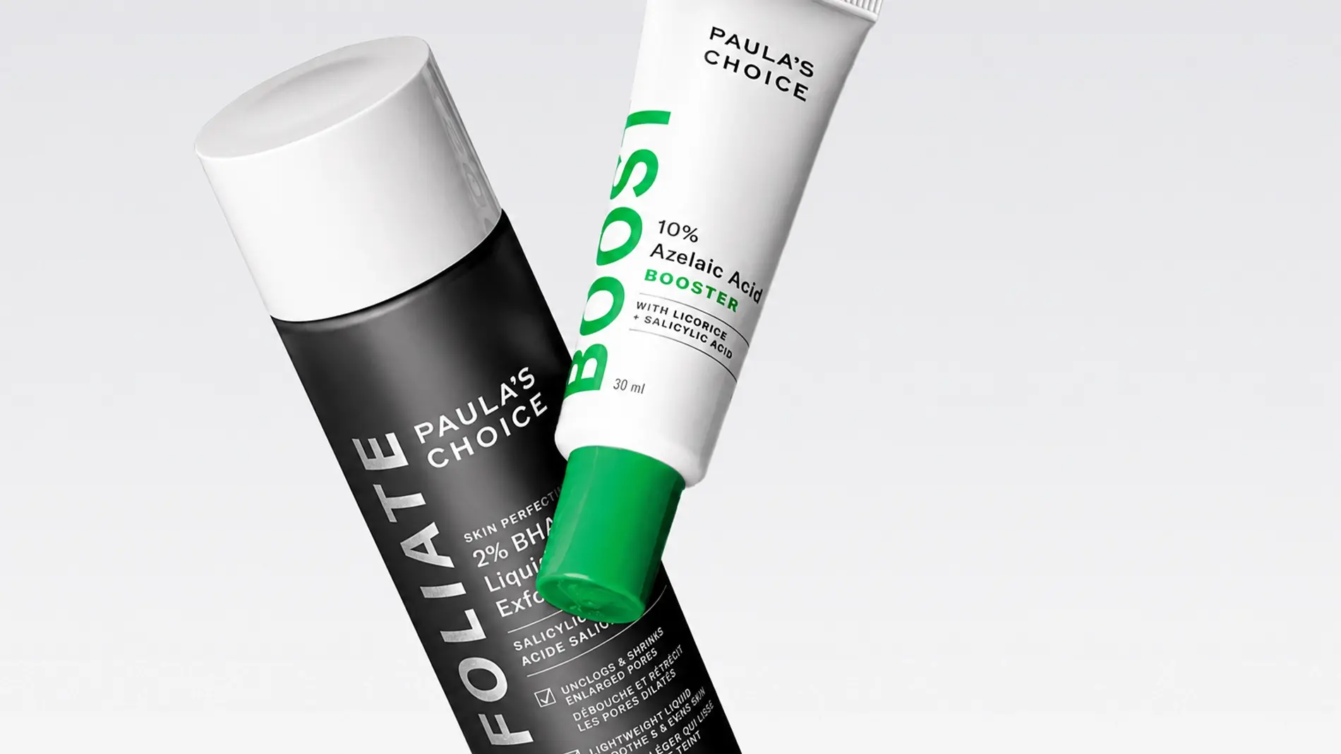 To hudpleieprodukter fra Paula’s Choice vises mot lys bakgrunn: Skin Perfecting 2% BHA Liquid Exfoliant og 10% Azelaic Acid Booster med teksten “PAULA’S CHOICE”, “BOOST” og “30 ml” synlig på emballasjen. Produktene fremhever eksfoliering og hudpleie med salisylsyre og azelainsyre.