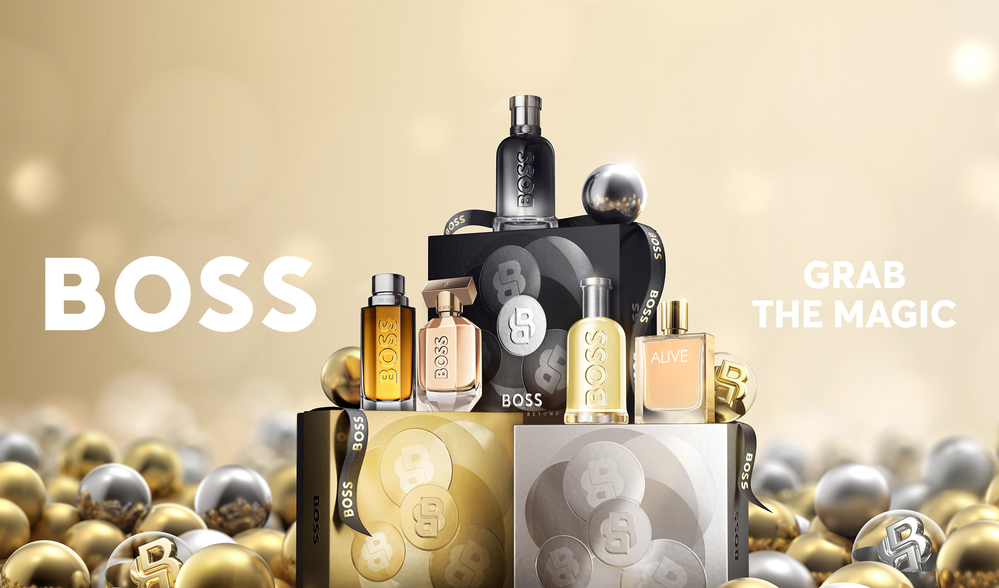 BOSS-produkterna är presenterade i en lyxig uppställning, omgivna av guld- och silverkulor. Texten "GRAB THE MAGIC" framhäver feststämningen.