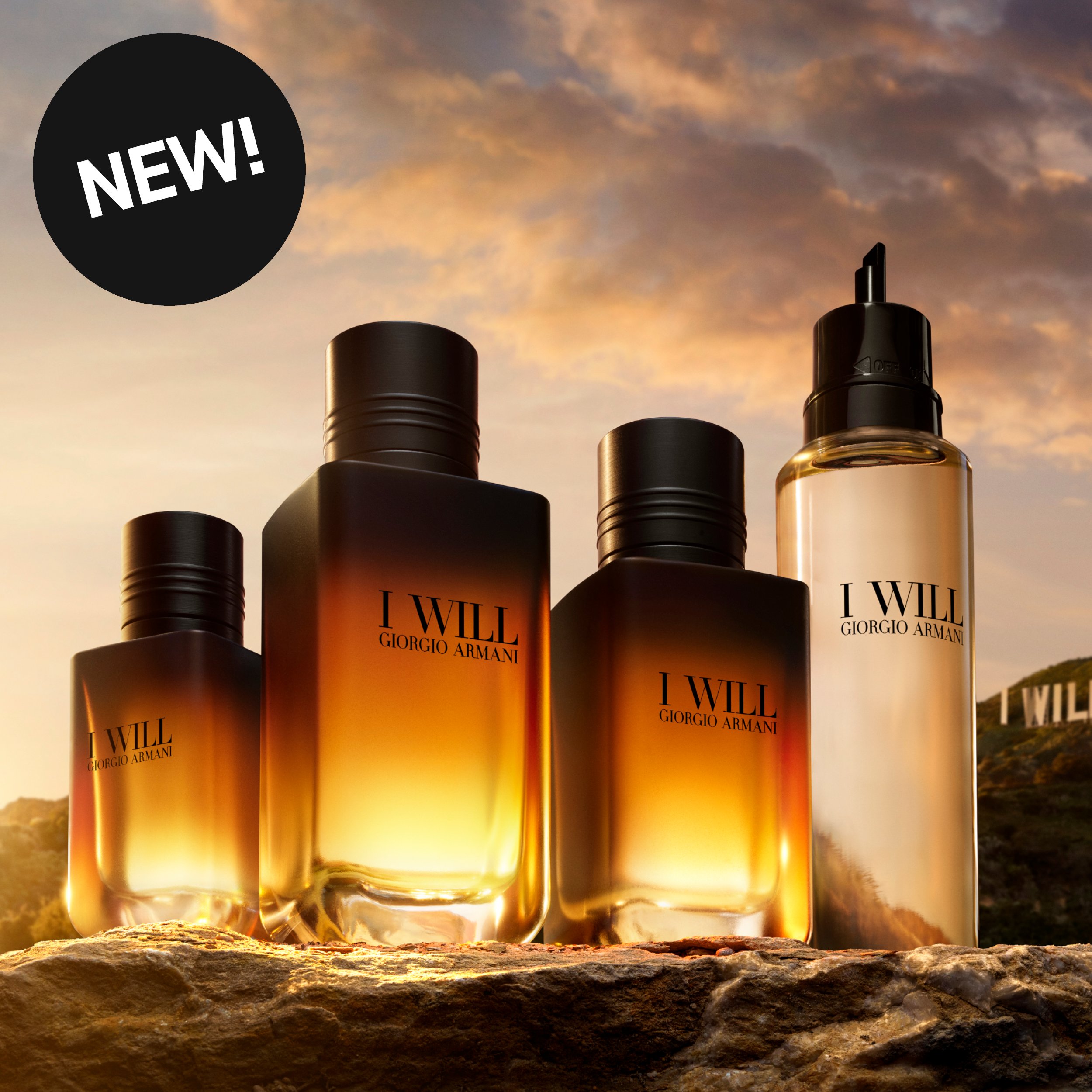 Giorgio Armani I Will-duftprodukter i varmt solnedgangslys. Bildet inneholder teksten «New!».