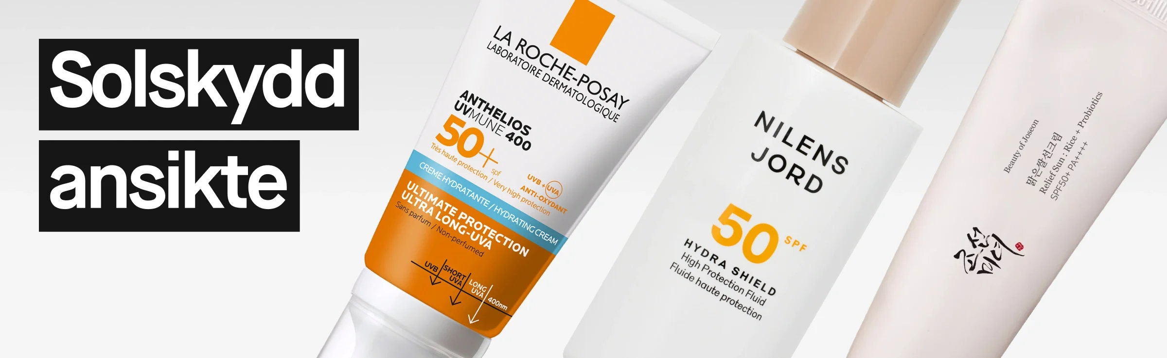 Flera solskydd för ansiktet lutade mot varandra, bland annat La Roche-Posay Anthelios SPF50+ och Nilens Jord Hydra Shield SPF50, mot ljus bakgrund.