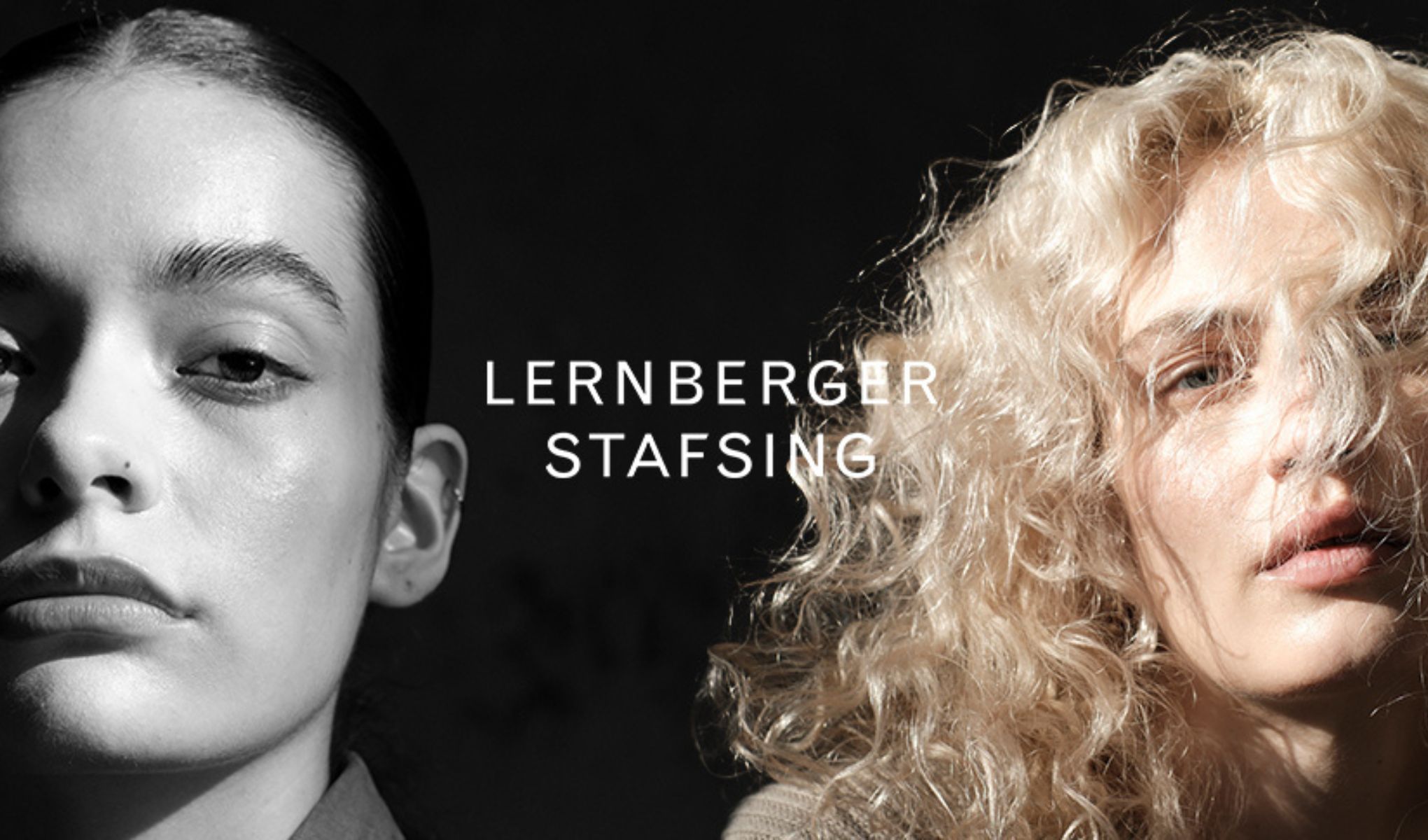 Kaksi ihmistä, vasemmalla tummahiuksinen ja oikealla kihara vaaleahiuksinen, seisovat tumman taustan edessä. Kuvan keskellä on teksti ”Lernberger Stafsing”.