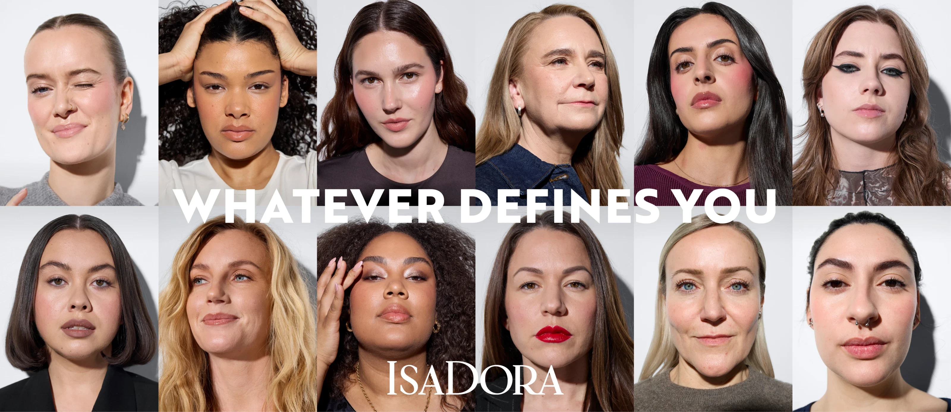 Useita ihmisiä, joilla on erilaisia hiustyylejä ja vaatteita, seisoo valkoista taustaa vasten, tekstillä "WHATEVER DEFINES YOU" ja "IsaDora" kirjoitettuna kuvan päälle.