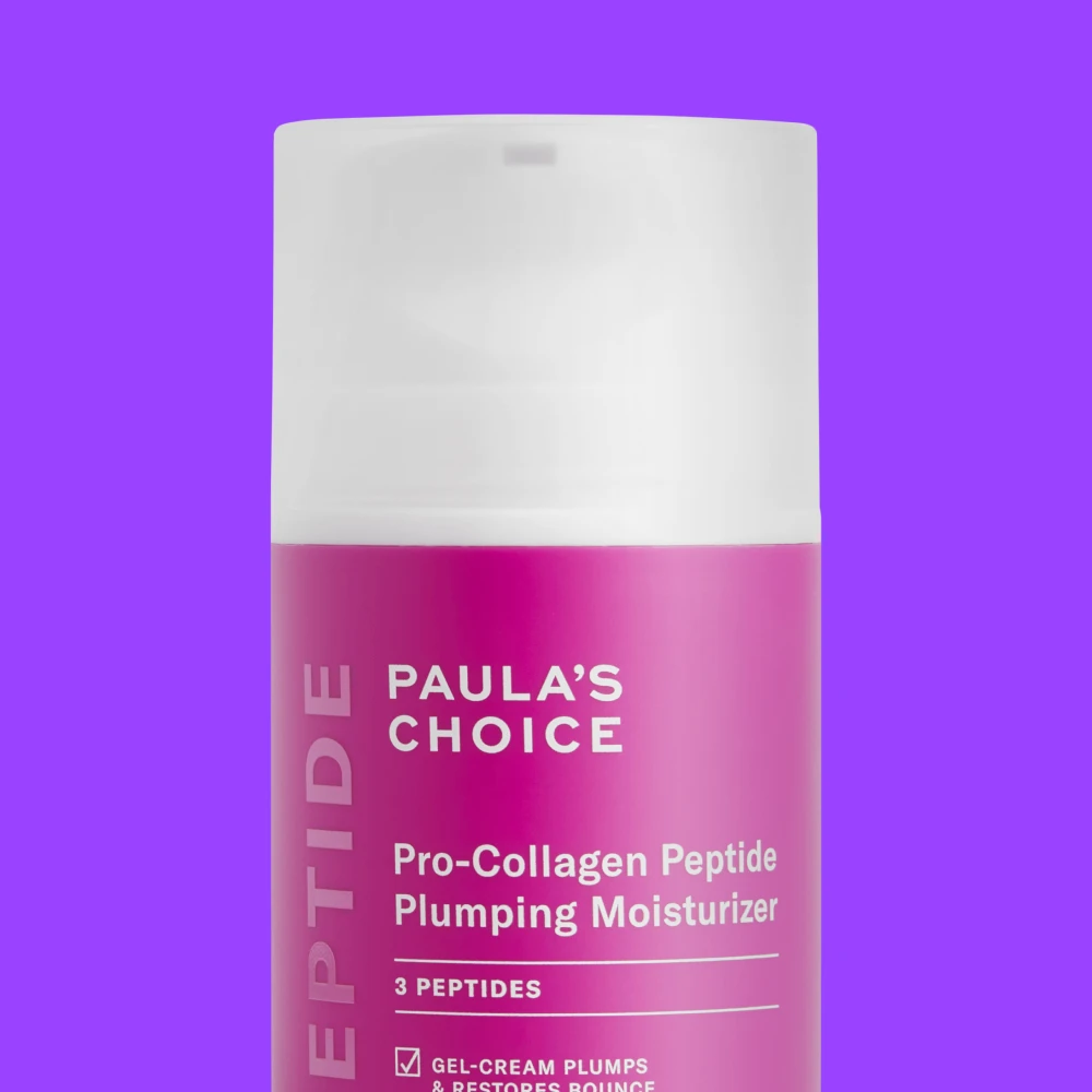 Paula's Choice Pro-Collagen Peptide Plumping Moisturizer vaaleanpunaisessa tuubissa violettia taustaa vasten.