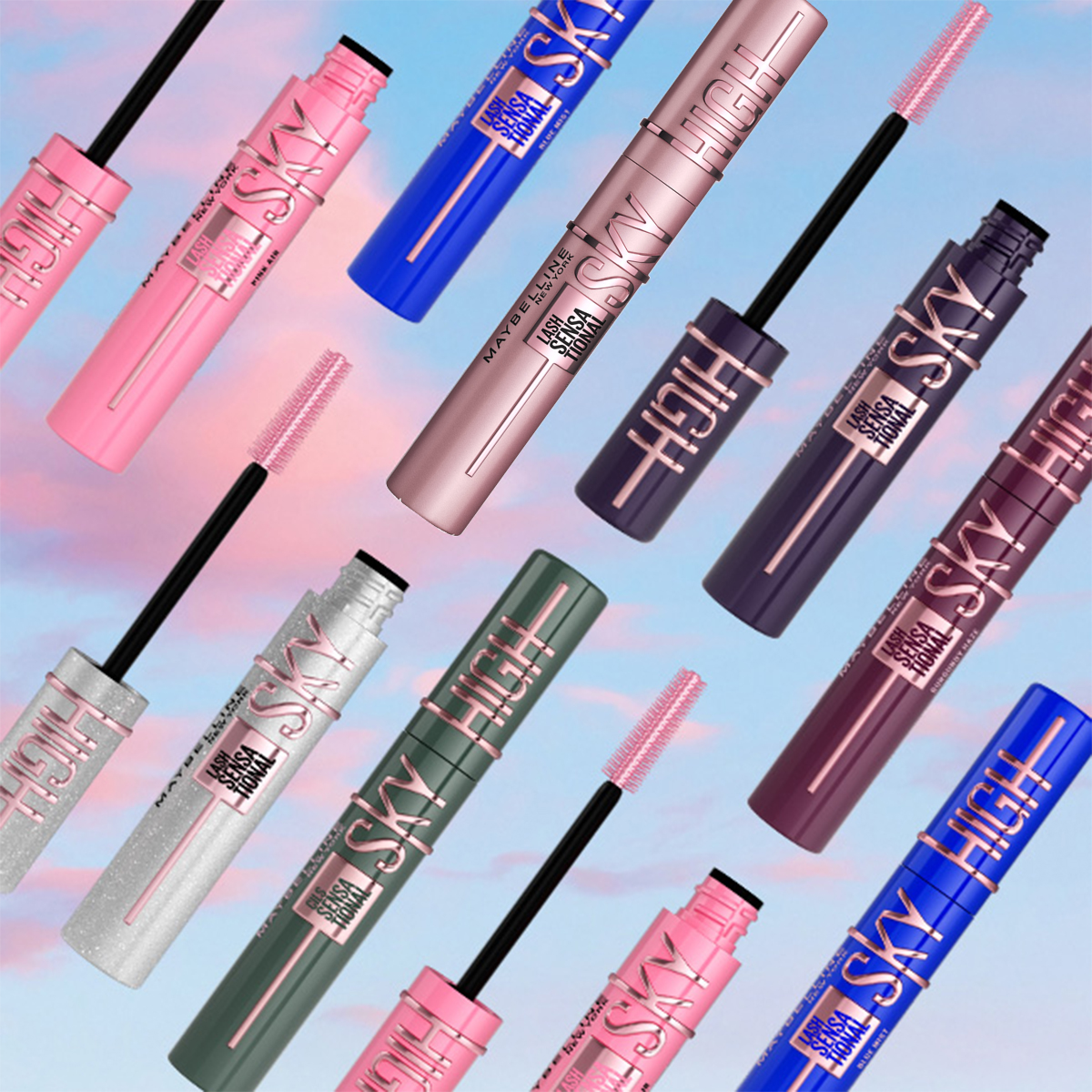 Useita Maybellinen erivärisiä ripsivärejä (vaaleanpunainen, sininen, hopea, vihreä ja violetti), jotka on aseteltu vaaleanpunaisten ja sinisten pilvien taustalle.