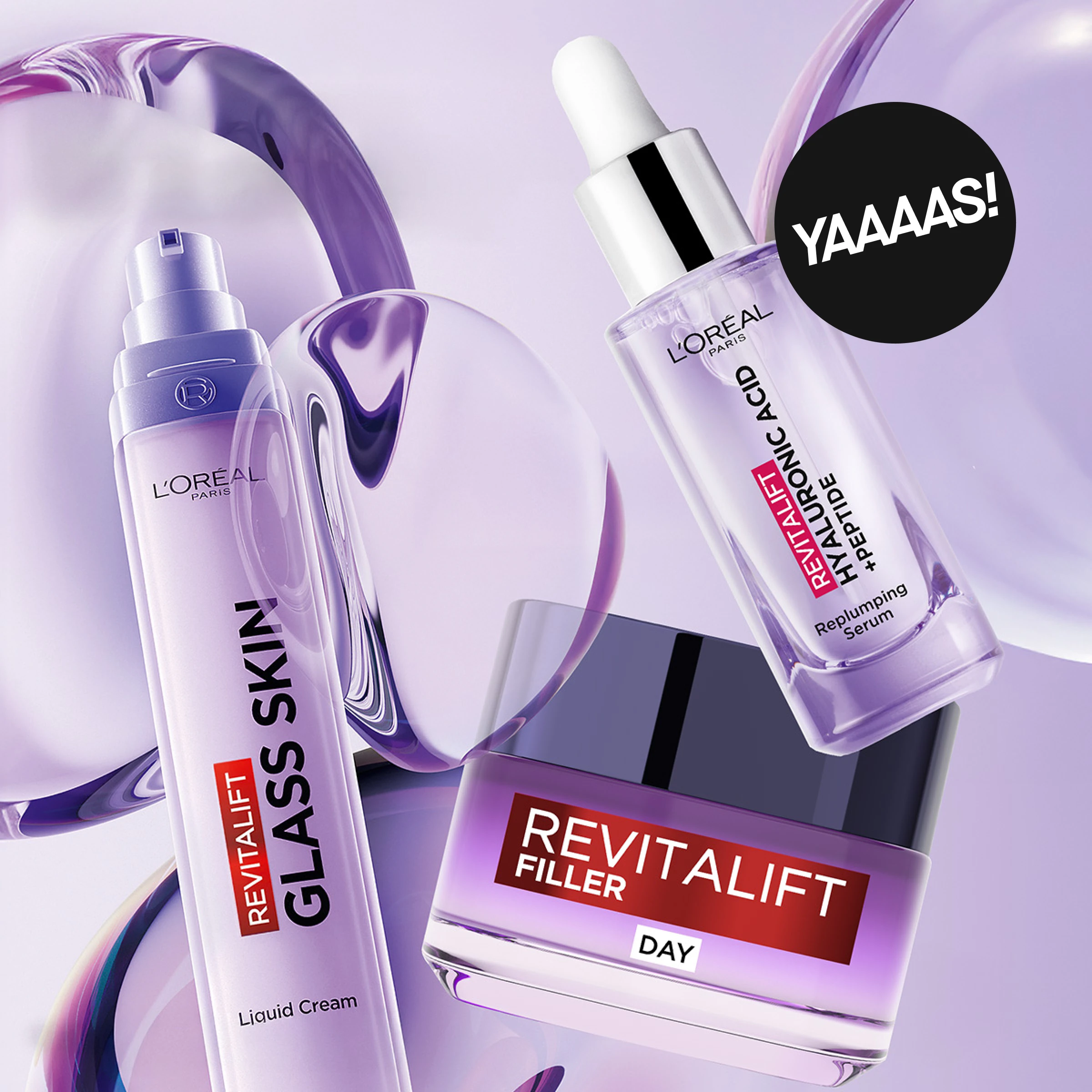 Hudvårdsprodukter från L’Oréal Paris Revitalift: “REVITALIFT GLASS SKIN Liquid Cream”, “REVITALIFT FILLER DAY” och “REVITALIFT HYALURONIC ACID + PEPTIDE Replumping Serum”. Produkterna presenteras mot en lila bakgrund med rund etikett med texten “YAAAS!”.