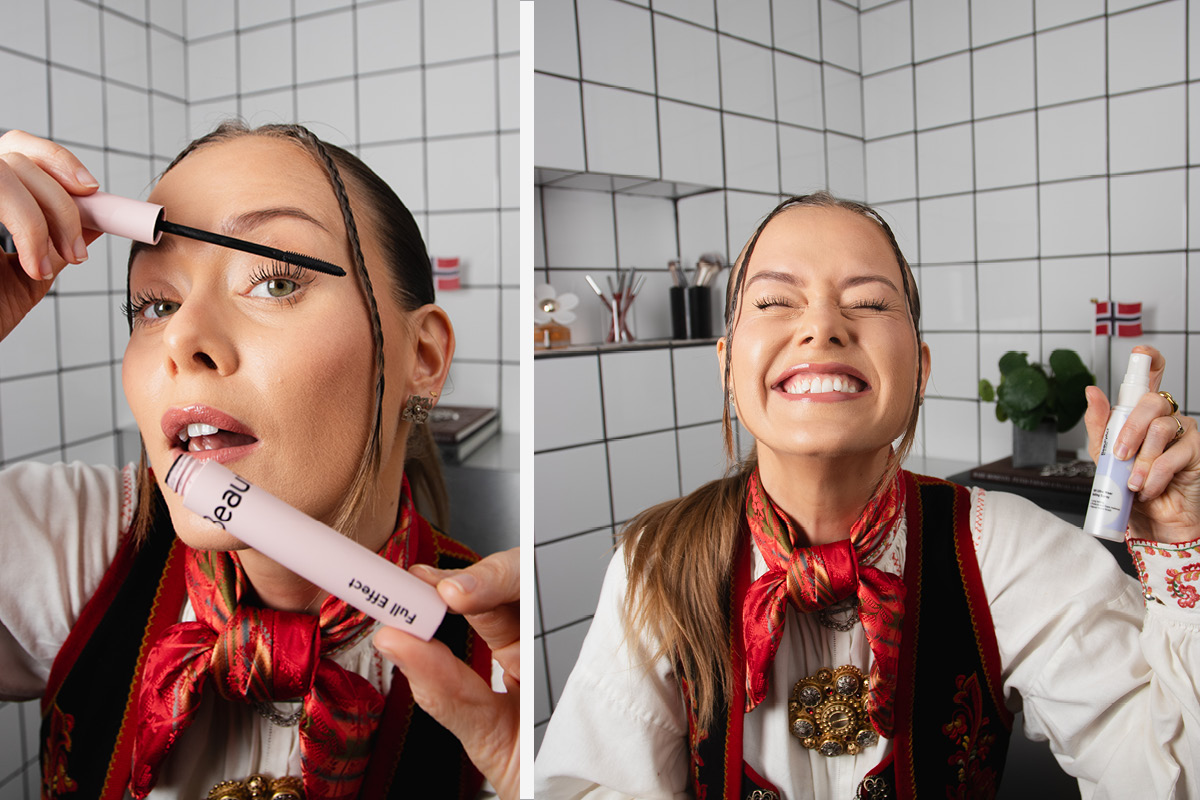 Person i bunad påfører mascara på badet