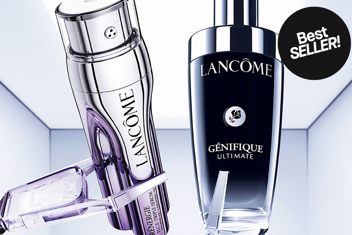 Lancôme-tuotteet, mukaan lukien uusi Génifique Ultimate -seerumi, esitetään modernissa ja tyylikkäässä ympäristössä. Vasemmalla on hopeinen pullo, oikealla tumma pullo, jossa lukee "NEW!".