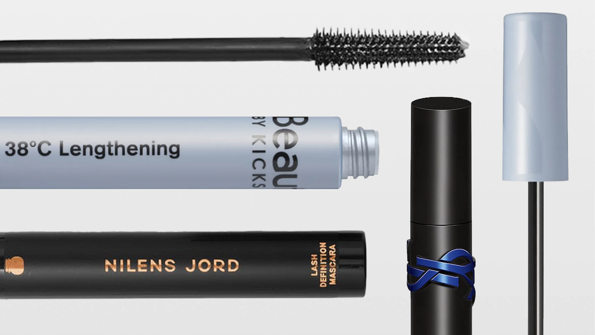 Useita ripsivärejä ja harjoja merkeiltä KICKS Beauty ja Nilens Jord, pakkauksissa tekstit "Beauty by KICKS" ja "NILENS JORD", mukana mustaa ripsivärimassaa ja avoimia pakkauksia vaalealla taustalla.