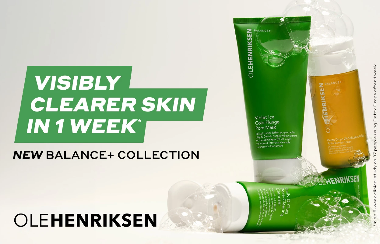 Kolme ihonhoitotuotetta Ole Henriksen Balance+ Collectionista vihreissä ja oransseissa pakkauksissa, vaahdon ympäröimänä. Kuvan teksti sanoo "Visibly clearer skin in 1 week".