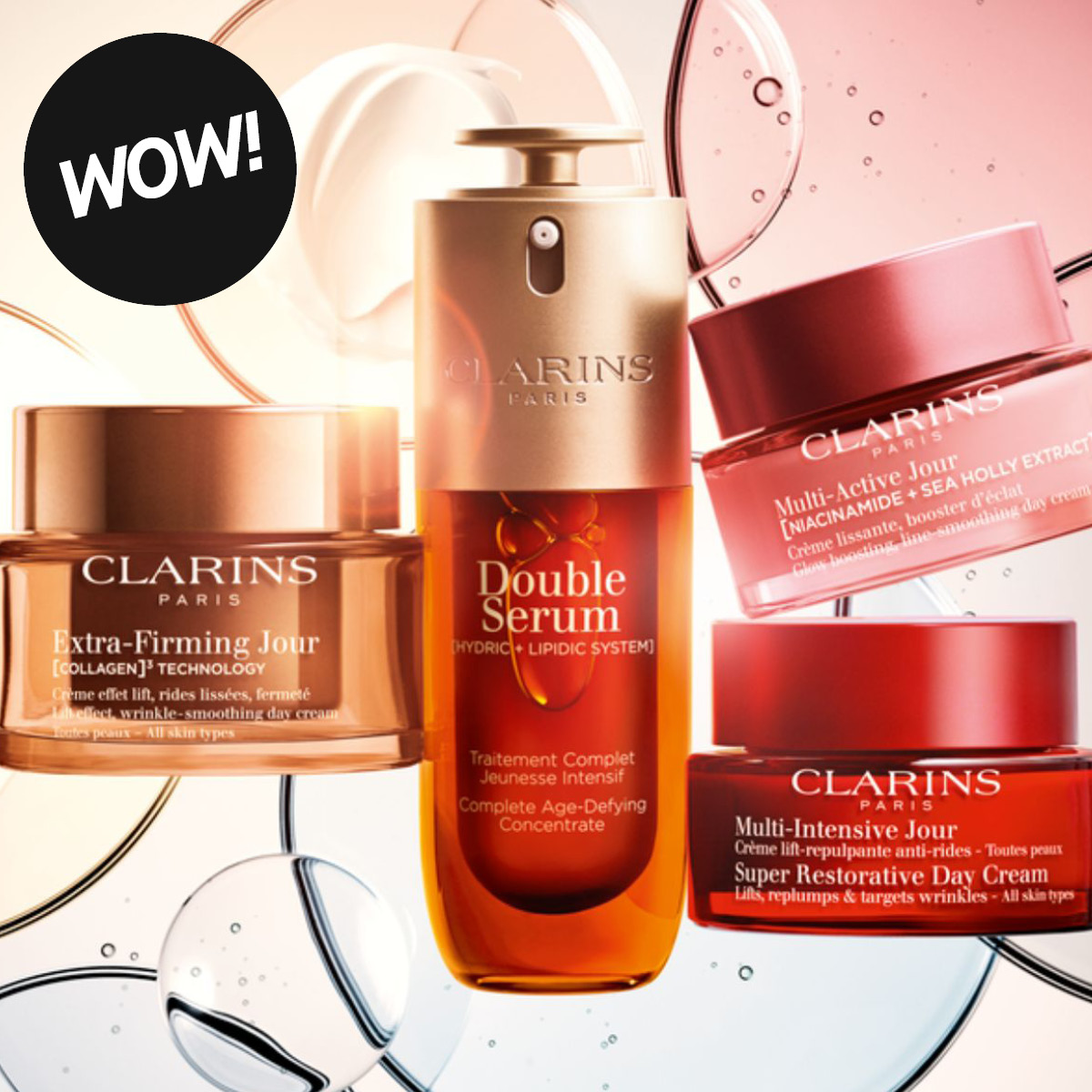 Tuotekuva tekstillä “WOW!” sekä Clarins-ihonhoitotuotteita vaaleaa taustaa ja läpinäkyviä kuplia vasten. Kuvassa näkyvät Clarins Double Serum, Extra-Firming Jour, Multi-Active Jour ja Multi-Intensive Jour Super Restorative Day Cream.