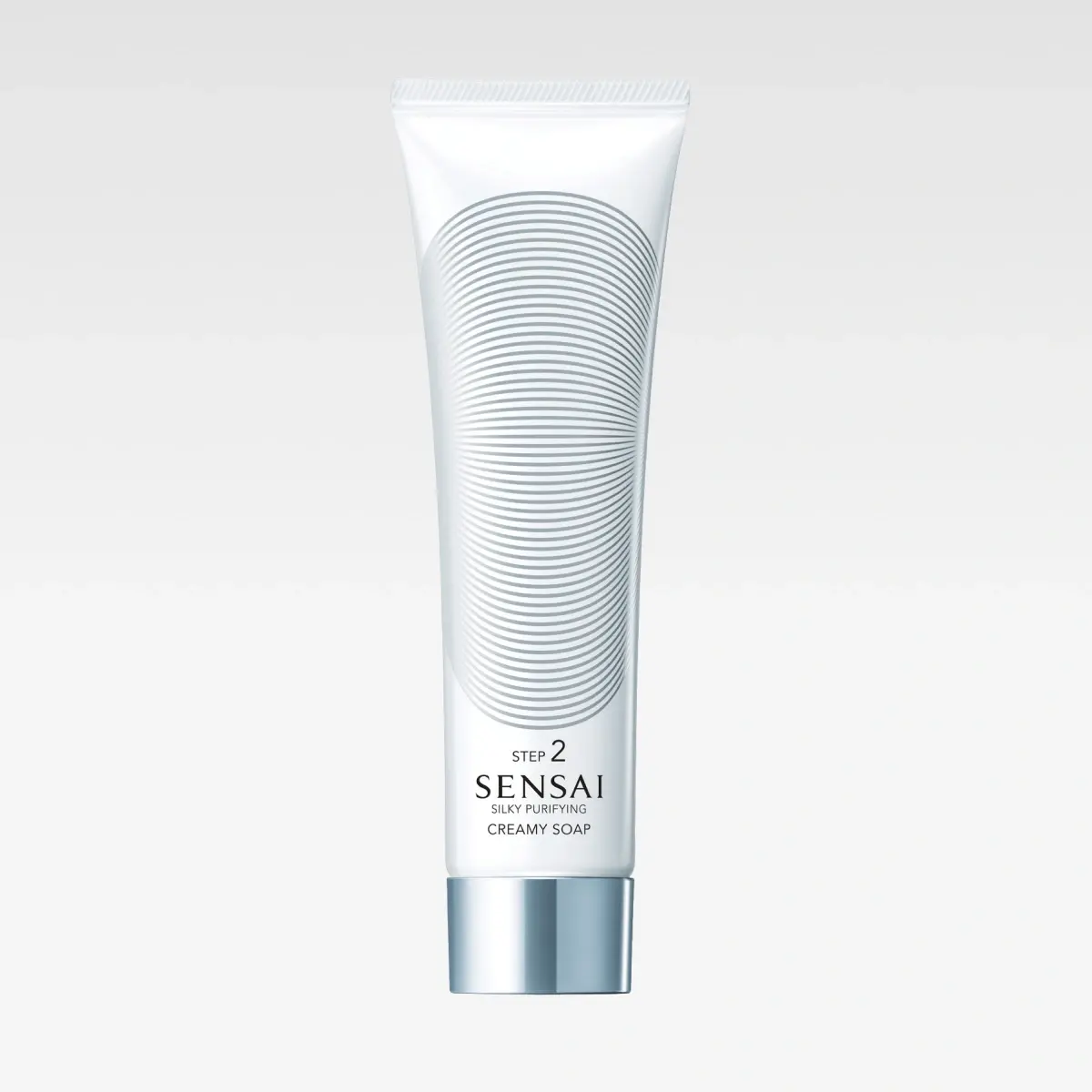Valkoinen tuubi SENSAI Silky Purifying Creamy Soap Step 2 -puhdistusvoidetta, jossa pyöreä kuvio ja hopeiset yksityiskohdat.