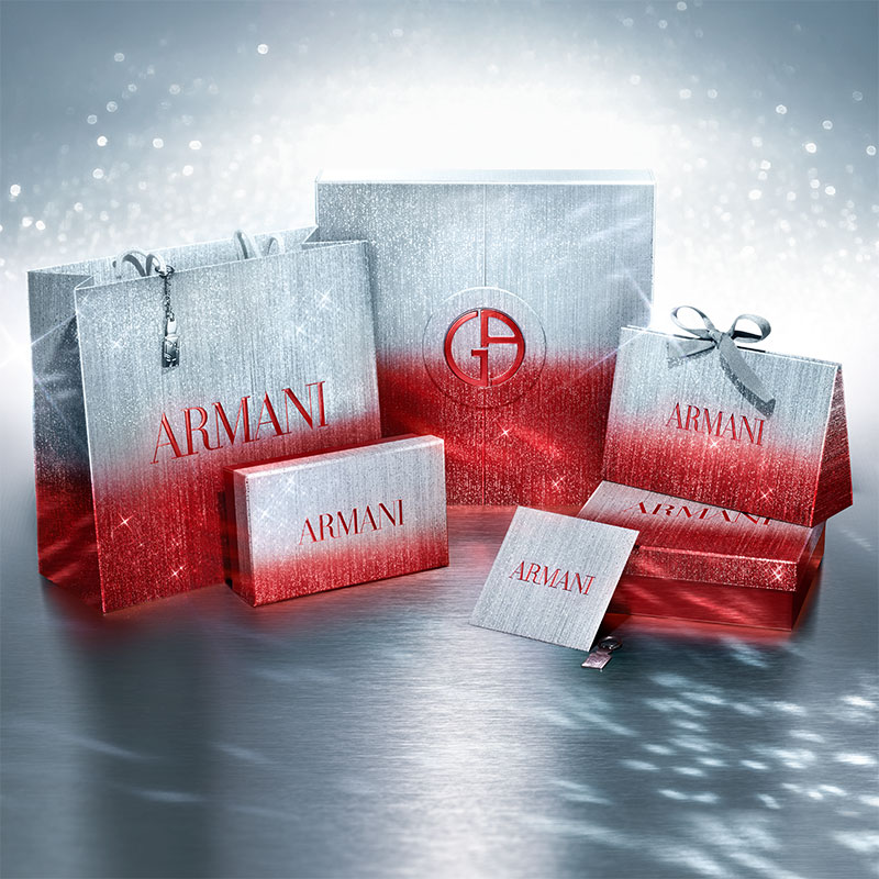Eleganta presentaskar från Armani – julklappar till Henne. Röda och vita påsar mot lyxig och exklusiv bakgrund.