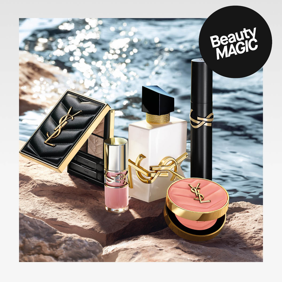 YSL-meikkejä ja hajuvesi aseteltuna kiville veden äärellä, tekstillä "Beauty MAGIC"