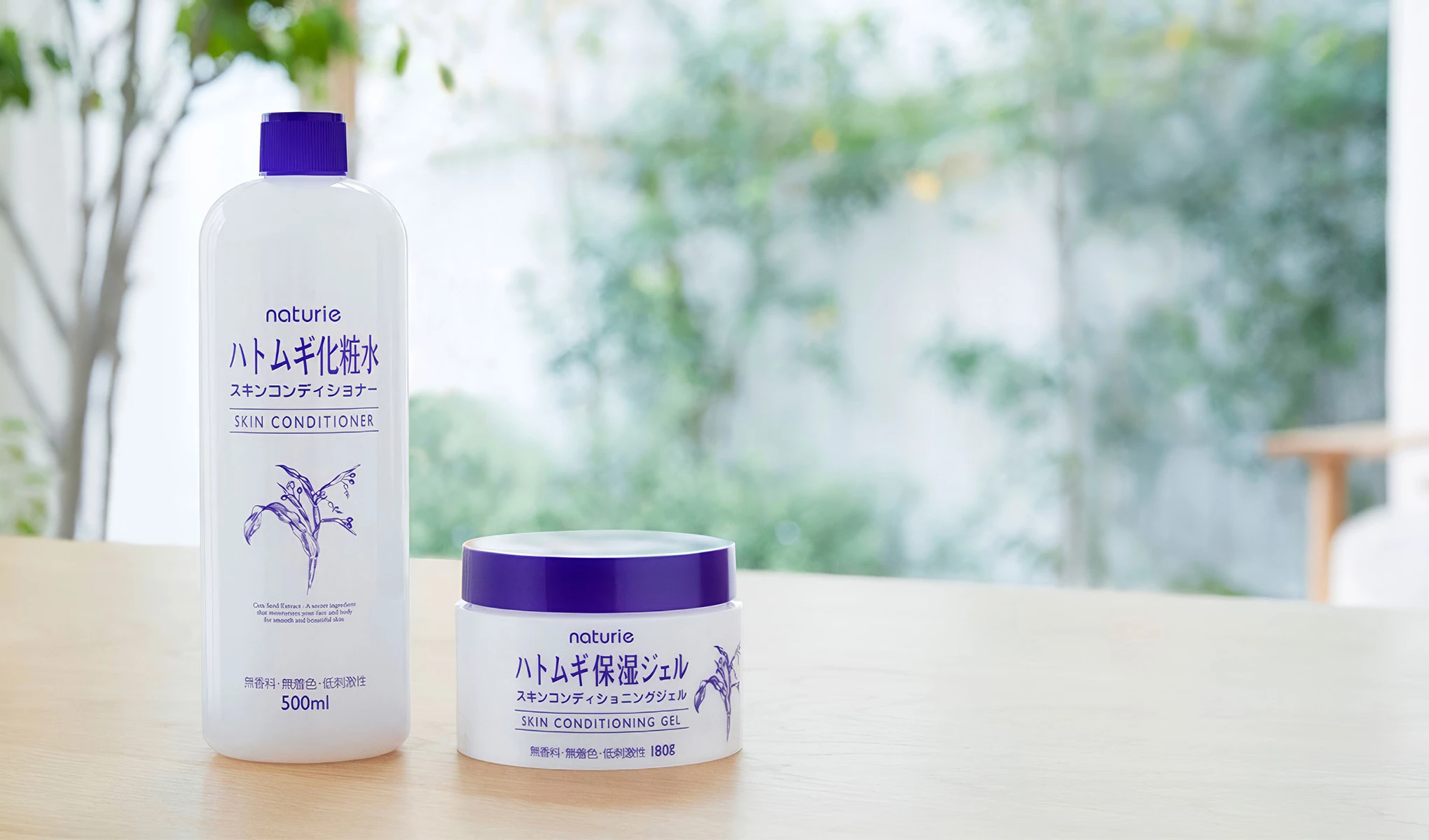 Kaksi Naturien tuotetta puupöydällä vehreän puutarhan taustaa vasten.
