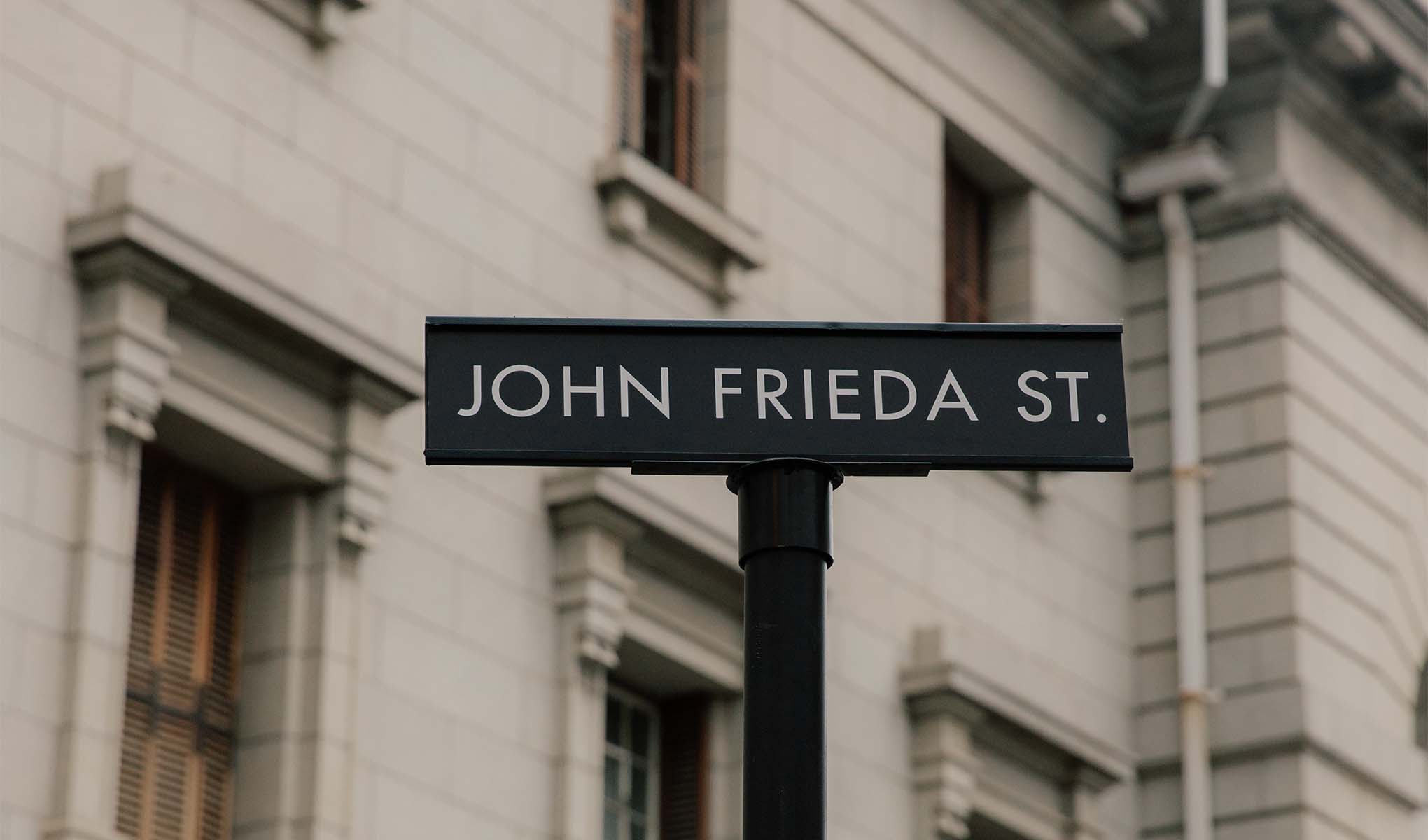 Et veiskilt med John Frieda St. på.