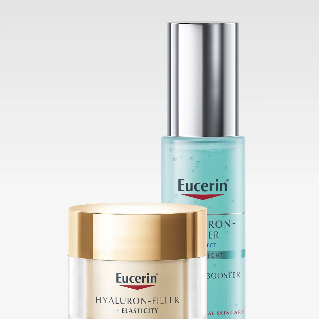 Bild som visar två Eucerin produkter: en blå flaska med Eucerin Hyaluron-Filler Moisture Booster och en vit burk med Eucerin Hyaluron-Filler + Elasticity. Bakgrunden är vit.