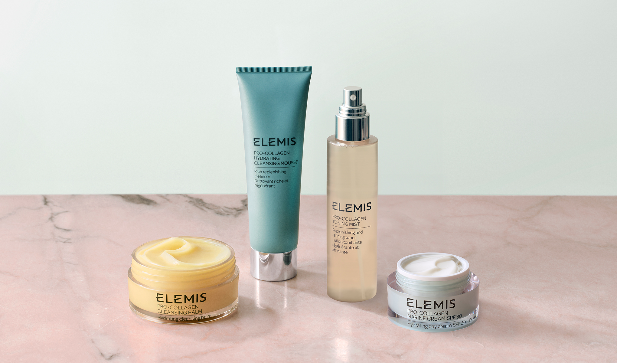 Elemis Pro-Collagen ihonhoitotuotteita (puhdistusbalmi, puhdistusvaahto, kasvovesi ja kasvovoide) marmoripinnalla.