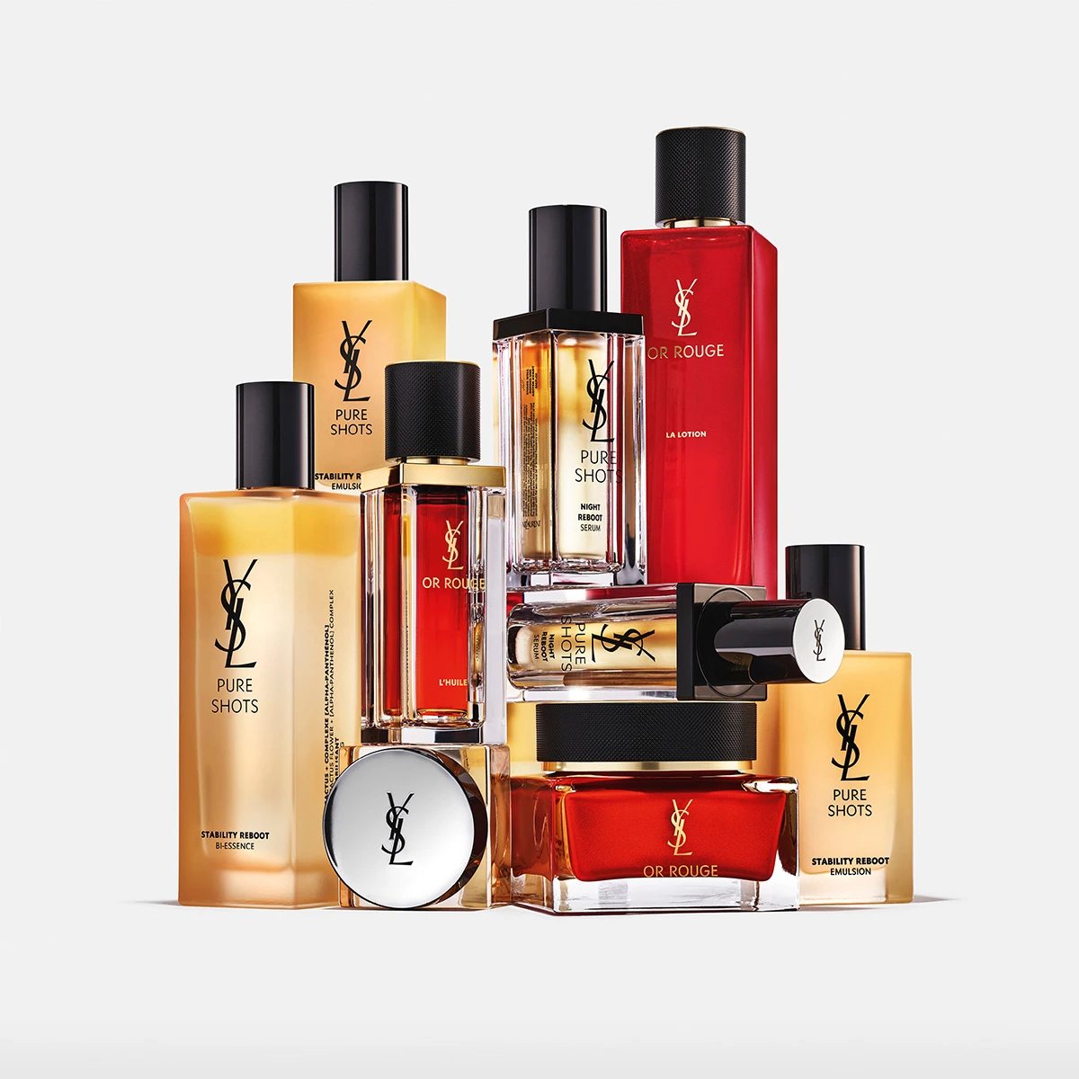 Samling av Yves Saint Laurent (YSL) Pure Shots och Or Rouge hudvårdsprodukter i röda och gyllene flaskor.