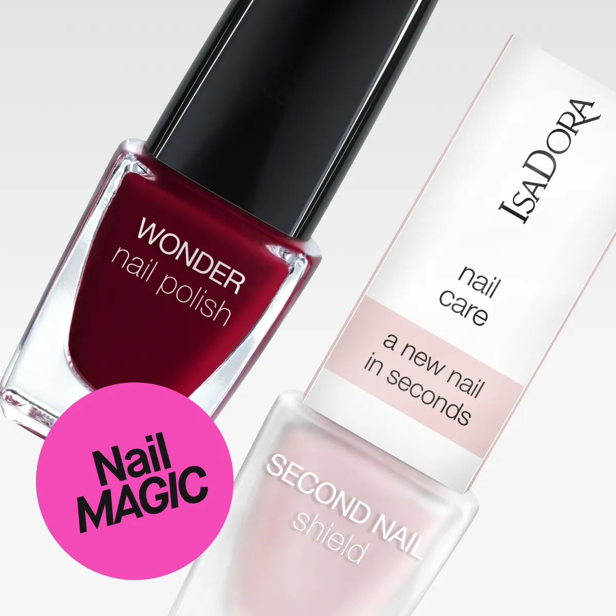Bild som visar två nagelprodukter från IsaDora: en flaska med IsaDora Wonder Nail Polish och en flaska med IsaDora Second Nail Shield. Texten "Nail MAGIC" är synlig i en rosa cirkel. Bakgrunden är vit.