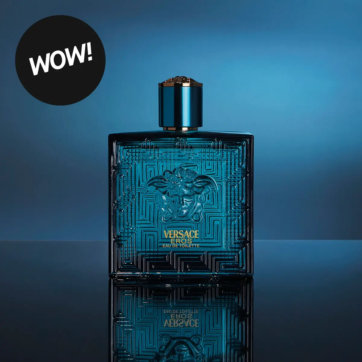 Versace Eros Eau de Toilette-flaska, mörk turkos med Medusa-huvud och grekiskt nyckelmönster, med en 'WOW!'-textbubbla.
