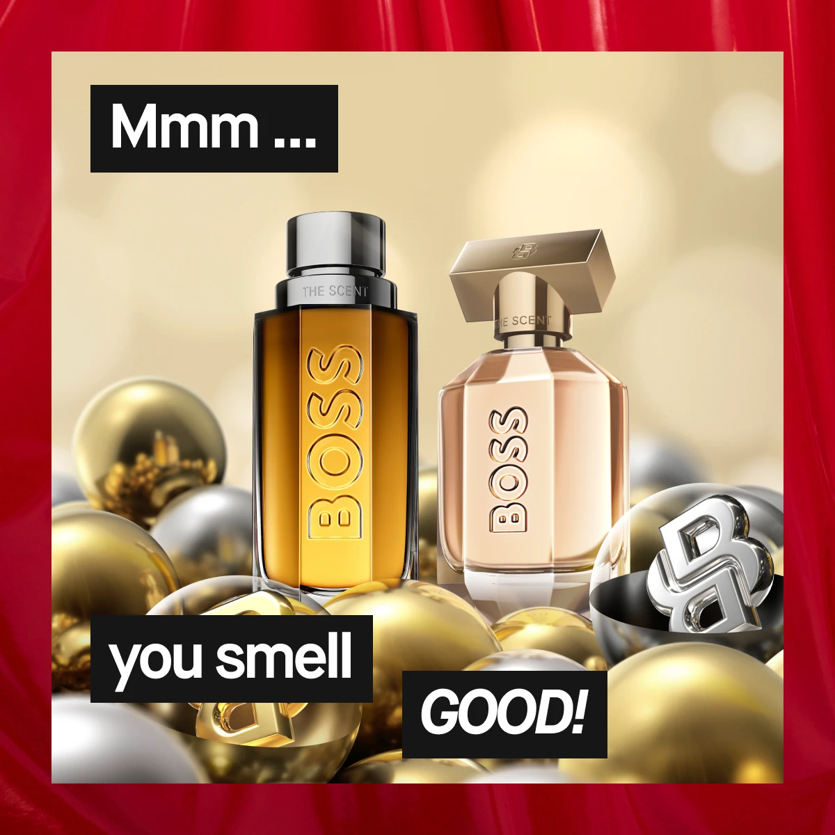 To Hugo Boss-dufter, en ravfarget og en rosétonet flaske, omgitt av gull- og sølvkuler mot lys bakgrunn med røde gardiner – elegant julekampanje.