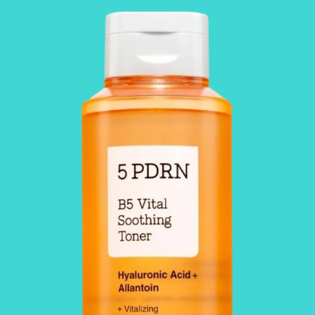 5 PDRN B5 Vital Soothing Toner i en orange flaska med vitt lock mot turkos bakgrund. På förpackningen syns texterna "5 PDRN", "B5 Vital Soothing Toner", "Hyaluronic Acid + Allantoin" och "+ Vitalizing".
