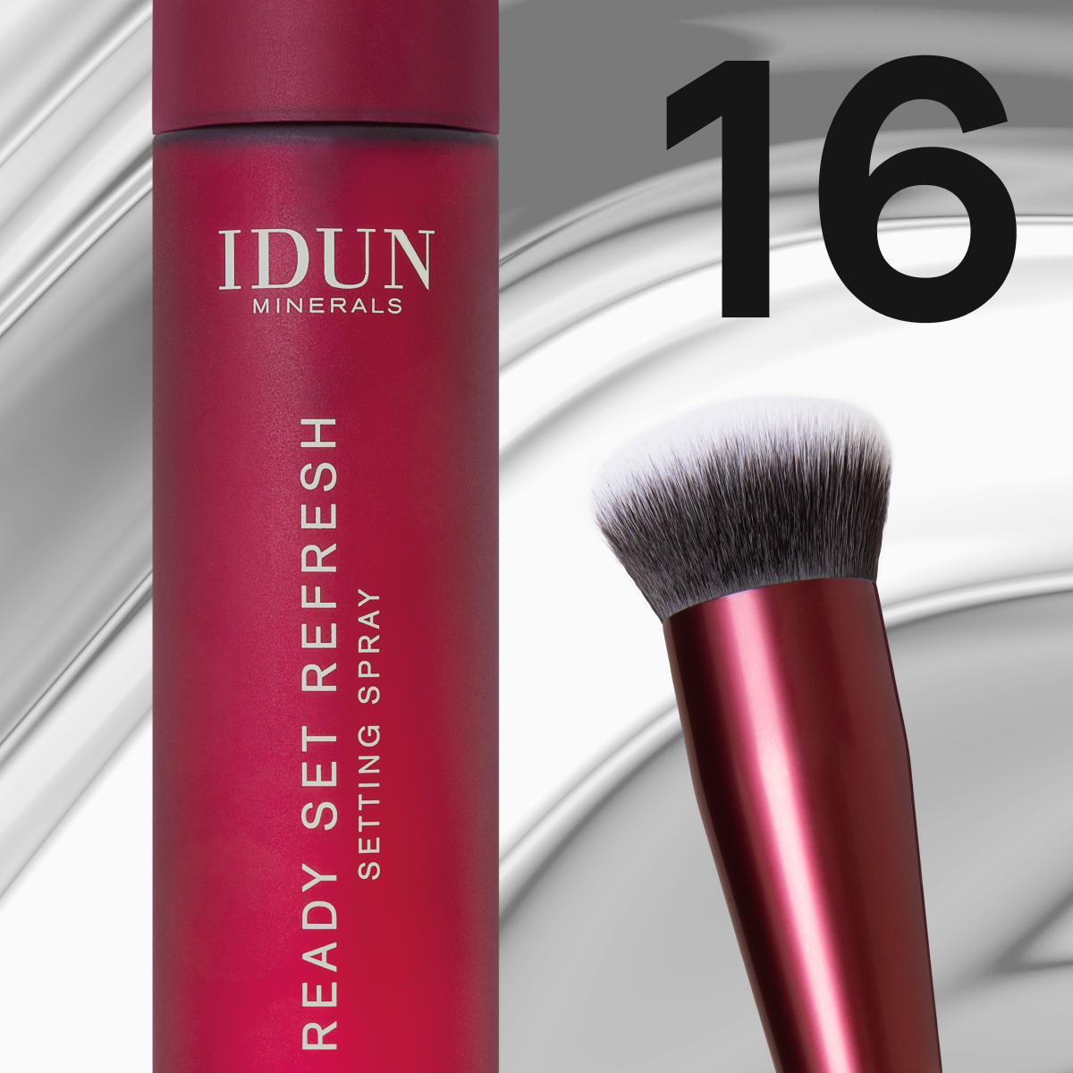 Röd setting spray och makeupborste från IDUN Minerals mot ljus metallisk bakgrund.