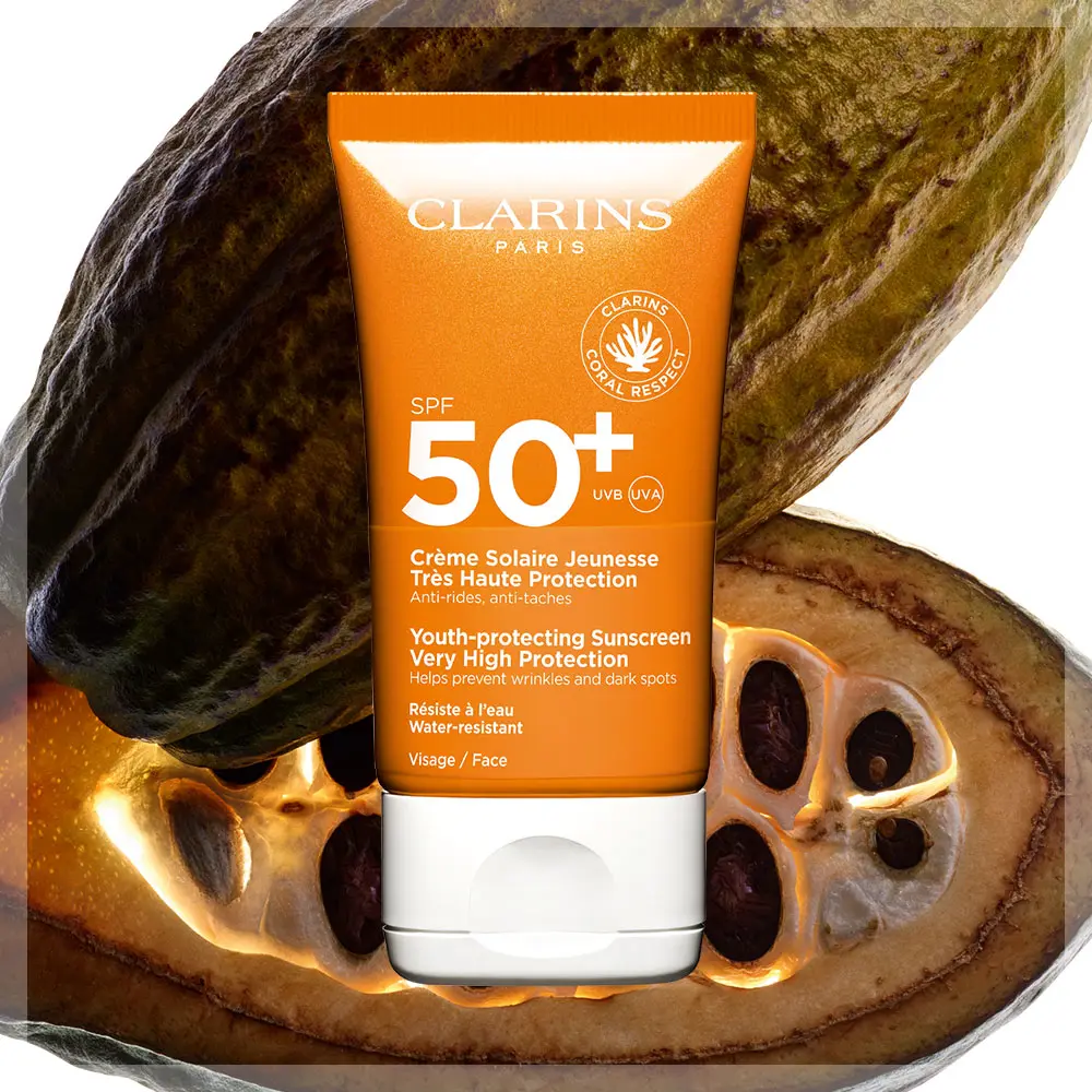 Clarins SPF 50+ -aurinkosuoja kaakaon hedelmien edessä.