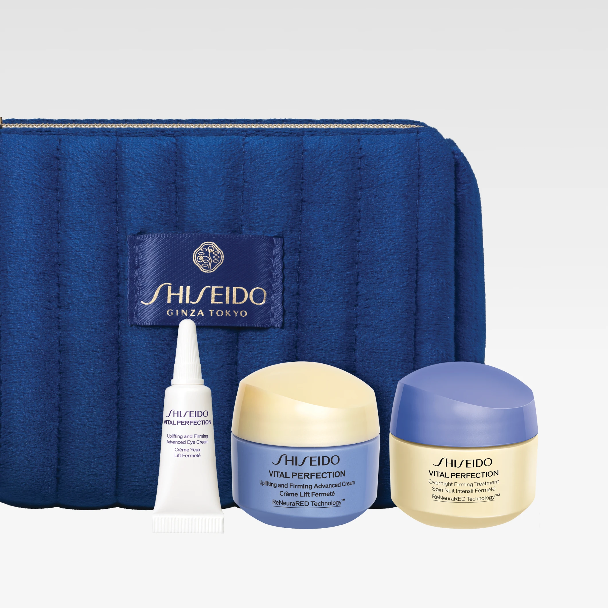 Shiseido-ihonhoitosetti, jossa sininen kosmetiikkalaukku tekstillä “SHISEIDO GINZA TOKYO” sekä useita “Vital Perfection” -voiteita ja silmänympärysvoide pienemmissä ko’oissa.