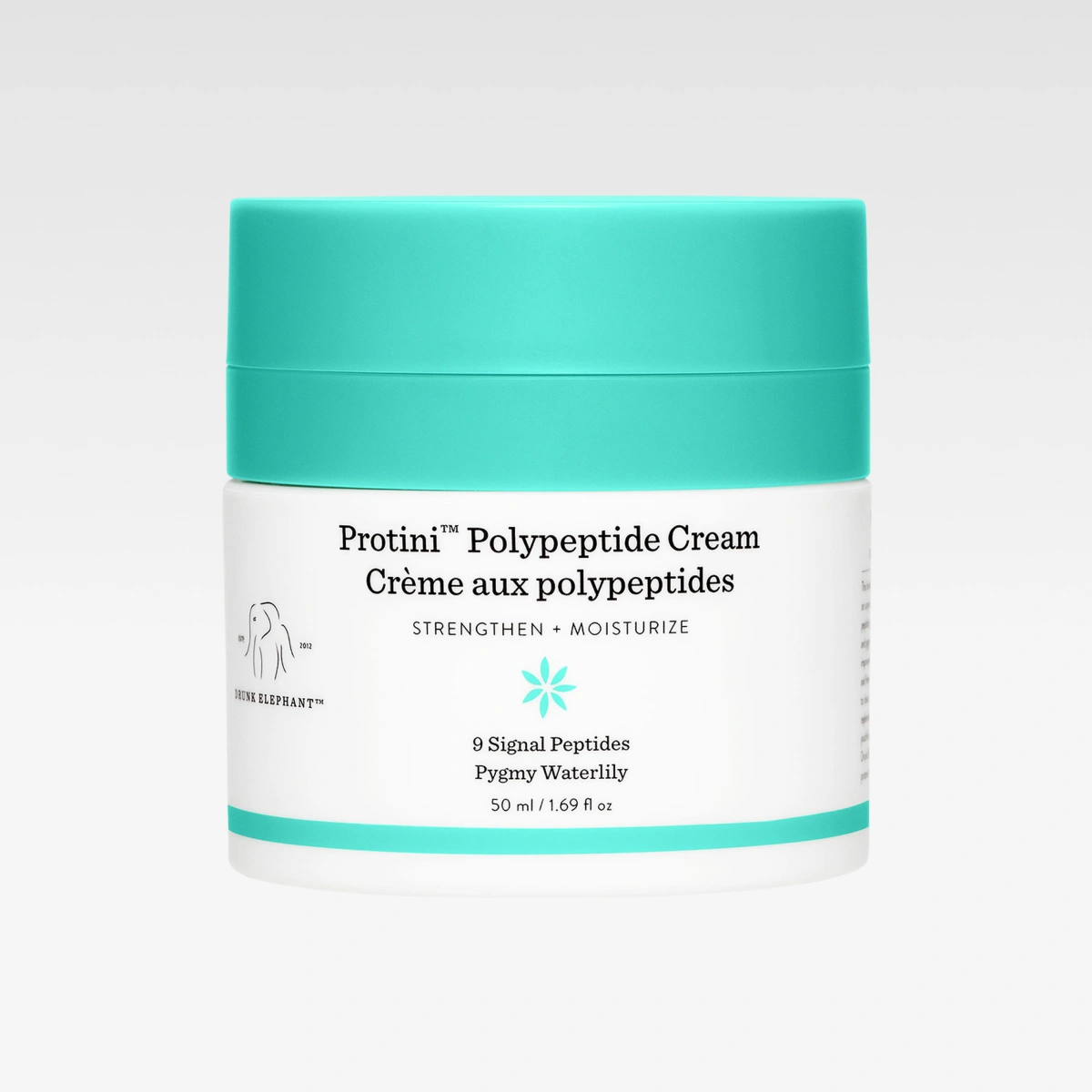 Drunk Elephant Protini Polypeptide Cream hudkrem i hvit krukke med turkis lokk mot lys grå bakgrunn. Synlig tekst inkluderer “Protini Polypeptide Cream”, “Strengthen + Moisturize” og “9 Signal Peptides Pygmy Waterlily”.