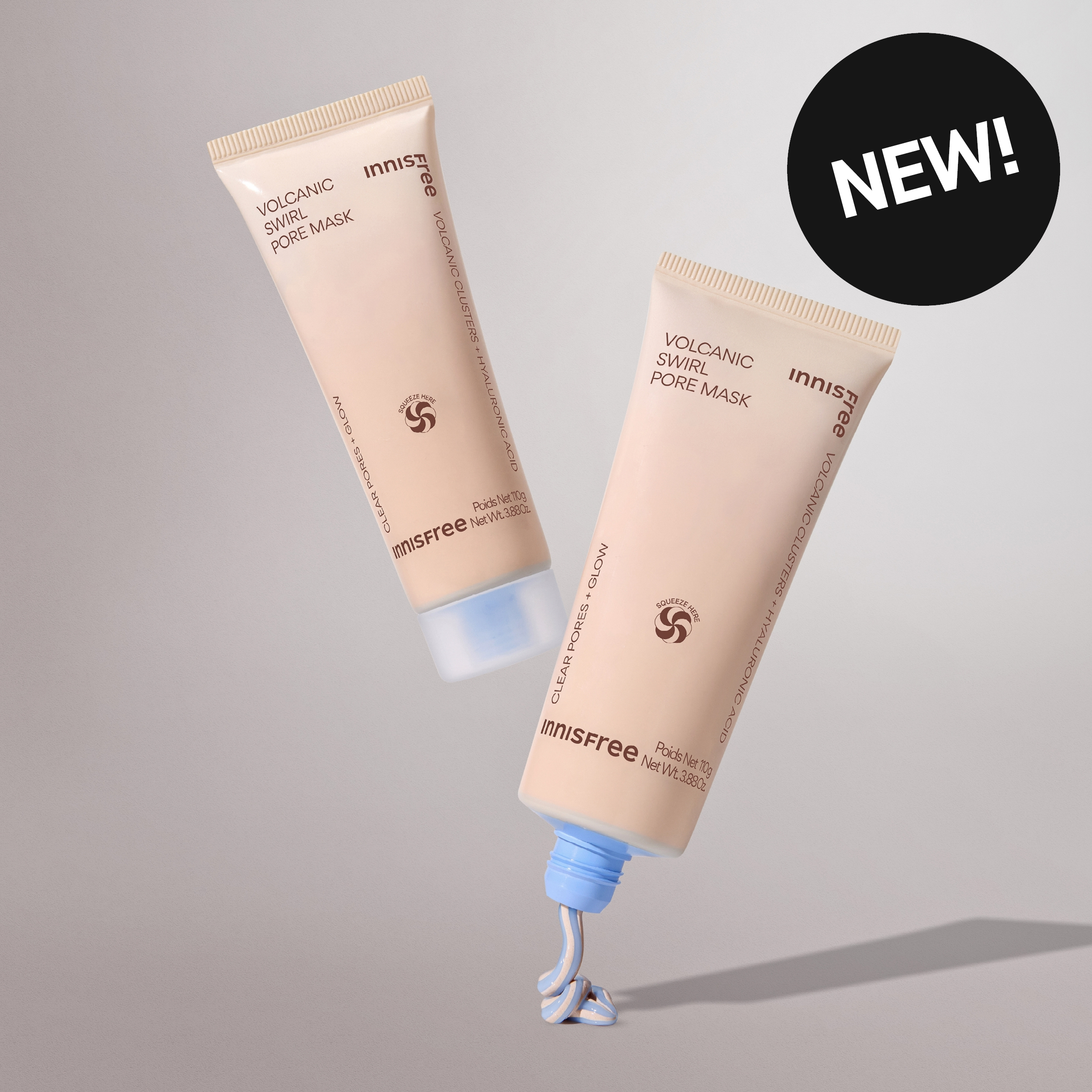 Kaksi Innisfree Volcanic Swirl Pore Mask -tuubia, joista toisesta puristuu voidetta; kuvassa “New”-merkintä.