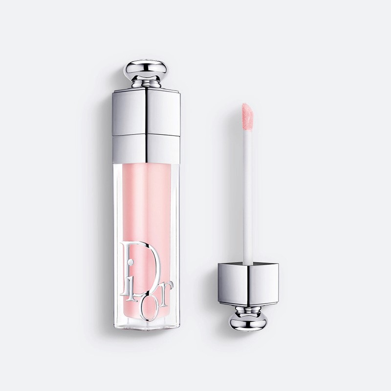 Dior Addict Lip Glow Oil i lys rosa nyanse, med flaske og applikator vist mot hvit bakgrunn.
