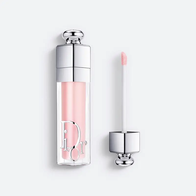 Dior Addict Lip Glow Oil i ljusrosa nyans, med flaska och applikator mot vit bakgrund.