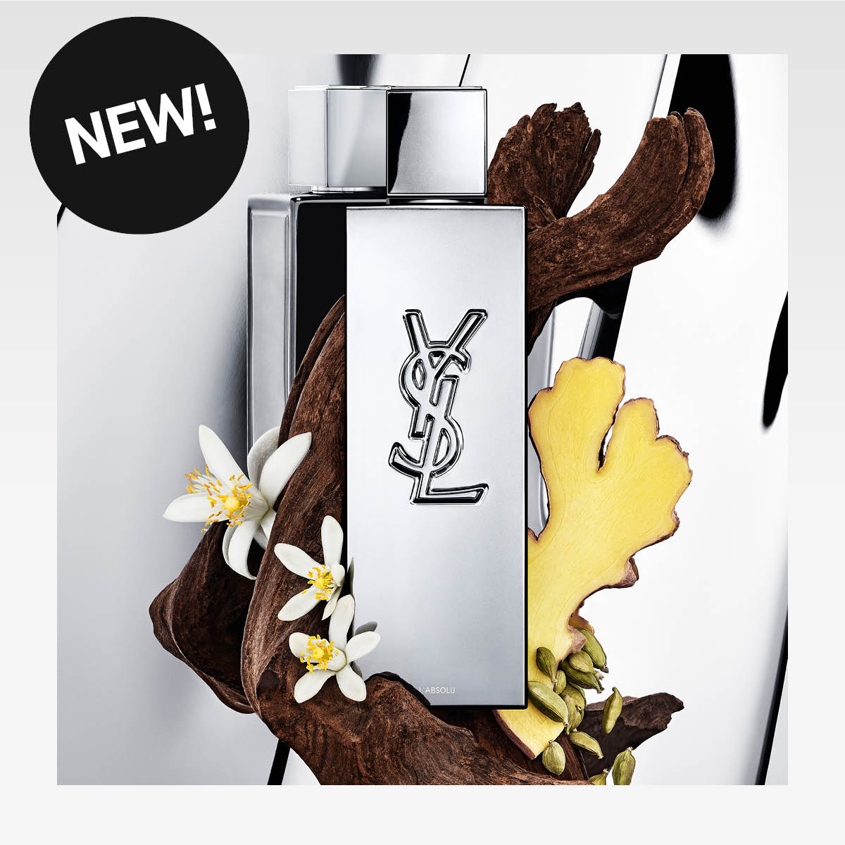 Musta MYSLF YSL -hajuvesi, vieressä valkoisia kukkia. Musta tarra tekstillä "NEW!".