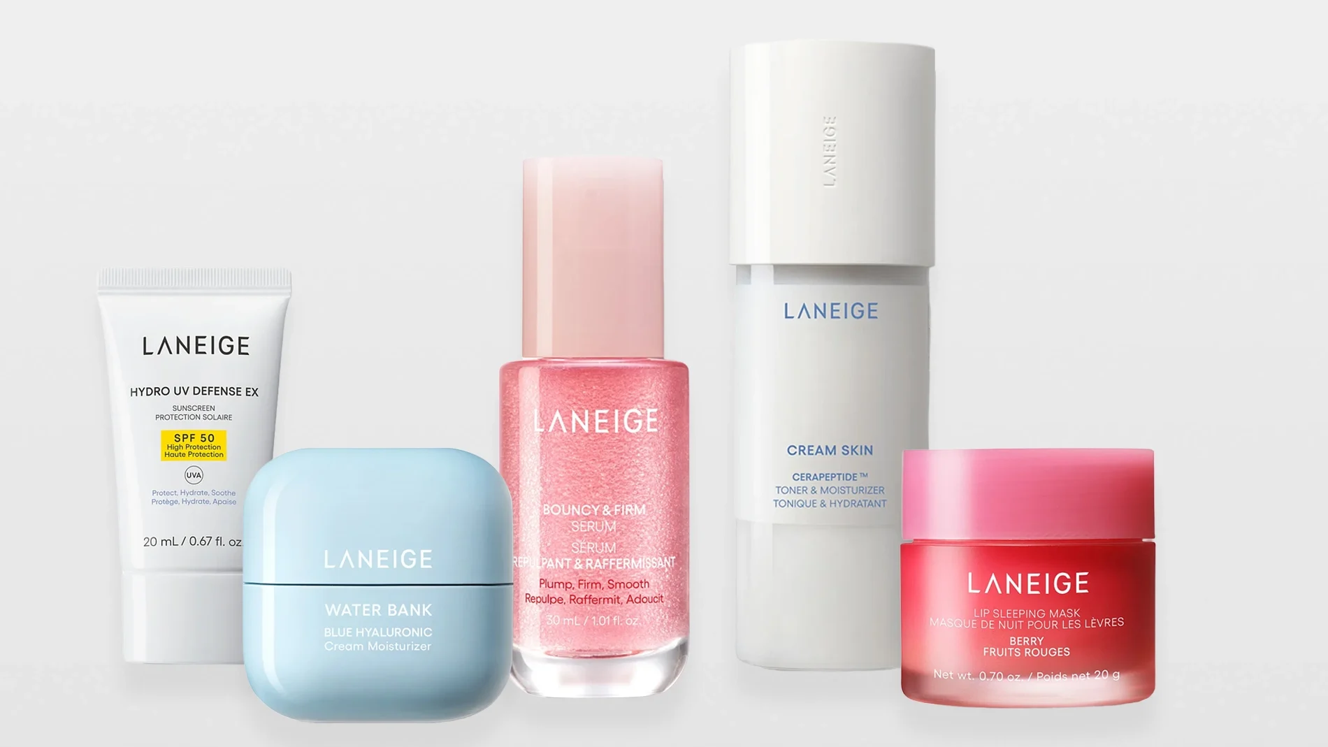 Produktbilde med flere hudpleieprodukter fra Laneige plassert mot lys bakgrunn. Bildet viser en hvit tube merket “Laneige Hydro UV Defense EX SPF 50”, en lyseblå krukke merket “Laneige Water Bank Blue Hyaluronic Cream Moisturizer”, en rosa flaske merket “Laneige Bouncy & Firm Serum”, en hvit flaske merket “Laneige Cream Skin Cerapeptide Toner & Moisturizer” samt en rosa krukke merket “Laneige Lip Sleeping Mask Berry”.