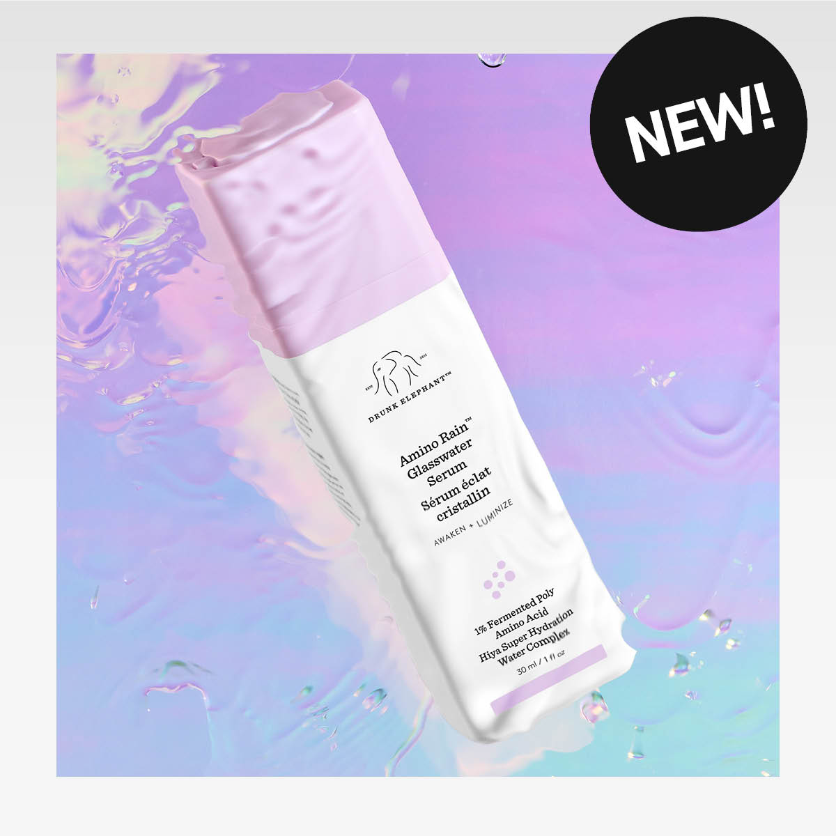 Drunk Elephant -tuotemerkki, Amino Rain Glasswater Serum -pullo holografisella taustalla. Pullossa on vaaleanpunainen korkki ja teksti "NEW!" mustassa ympyrässä.