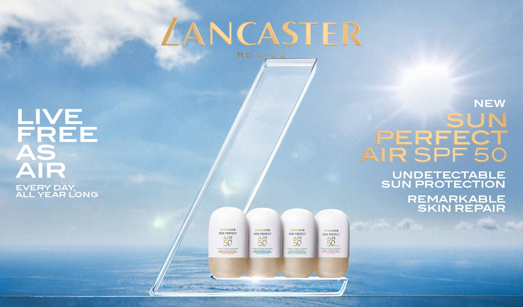 Kampanjebilde fra Lancaster Monaco med fire solbeskyttelsesprodukter “Sun Perfect Air SPF 50” plassert i en transparent display mot hav og himmel. Tekst i bildet: “LANCASTER MONACO”, “LIVE FREE AS AIR”, “EVERY DAY, ALL YEAR LONG”, “NEW SUN PERFECT AIR SPF 50”, “UNDETECTABLE SUN PROTECTION” og “REMARKABLE SKIN REPAIR”.