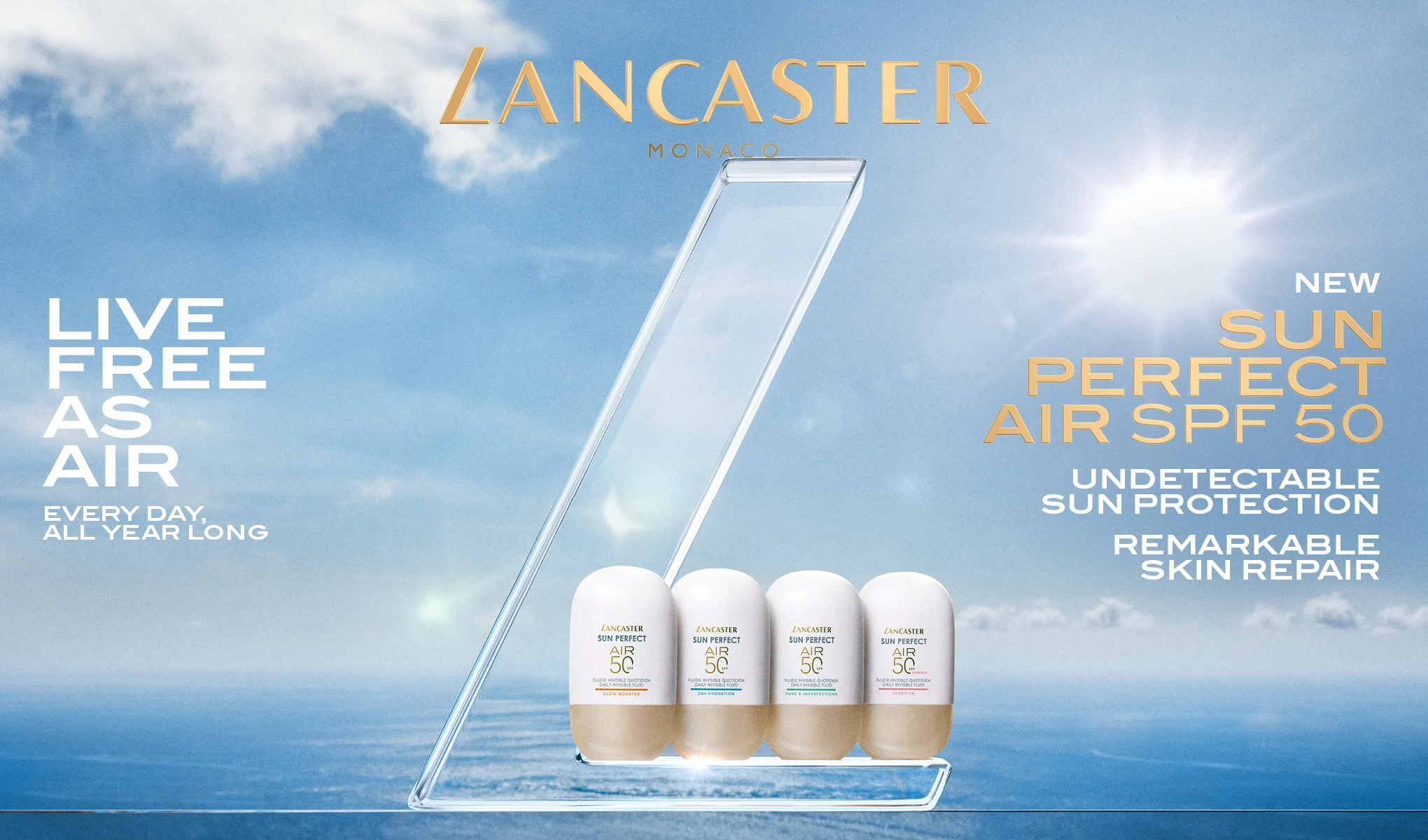 Kampanjebilde fra Lancaster Monaco med fire solbeskyttelsesprodukter “Sun Perfect Air SPF 50” plassert i en transparent display mot hav og himmel. Tekst i bildet: “LANCASTER MONACO”, “LIVE FREE AS AIR”, “EVERY DAY, ALL YEAR LONG”, “NEW SUN PERFECT AIR SPF 50”, “UNDETECTABLE SUN PROTECTION” og “REMARKABLE SKIN REPAIR”.
