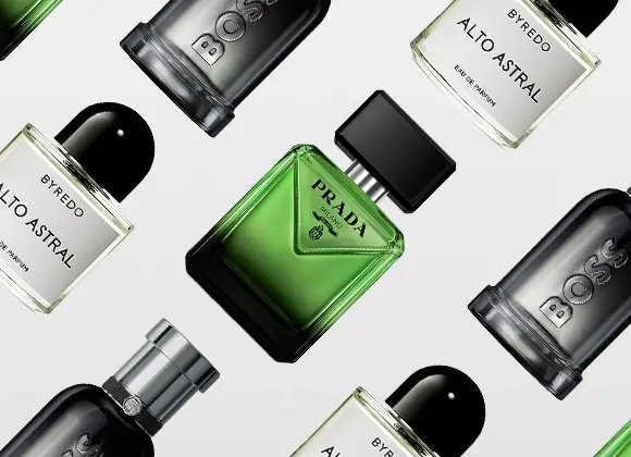 En stilren bild med flera herrparfymer arrangerade mot en ljus bakgrund: en grön fyrkantig flaska från Prada, svarta flaskor från Hugo Boss samt genomskinliga flaskor med svart kork från Byredo Alto Astral. Perfekt inspiration för fars dag eller som presenttips för män.