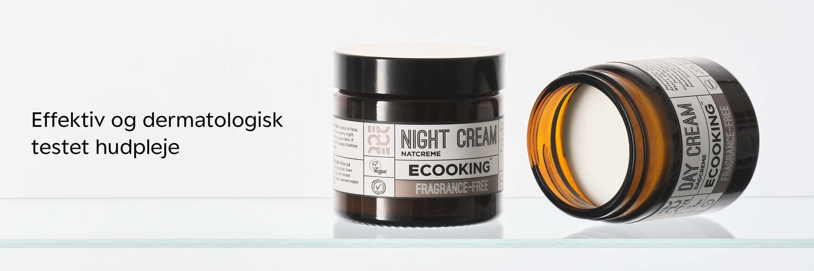 Ecooking Night Cream og Day Cream i mørke glas på hvid baggrund med teksten “Effektiv og dermatologisk testet hudpleje”.